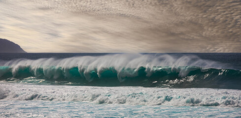Tubular waves developing late in the afternoon at Sunset Beach, Oahu, Hawaii.