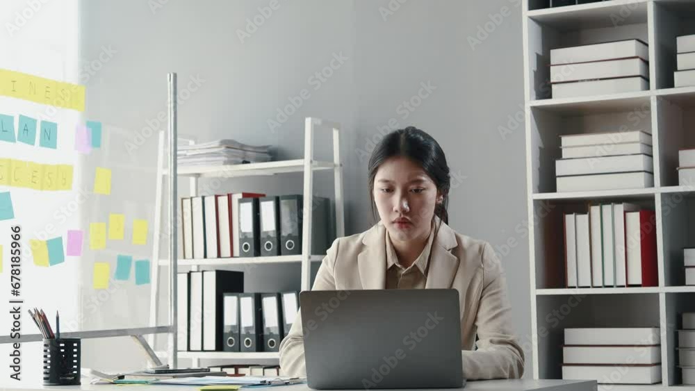 Wall mural Asian woman sitting in office, businesswoman in finance and accounting is working, collecting financial documents to summarize financial statements, profit and loss statement, accounting concept.