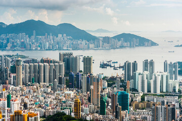 Panorama aerial view of Hong Kong Kowloon's crowded buildings and Victoria Harbour in China. - obrazy, fototapety, plakaty