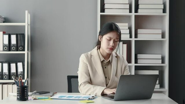 Asian woman sitting in office, businesswoman in finance and accounting is working, collecting financial documents to summarize financial statements, profit and loss statement, accounting concept.