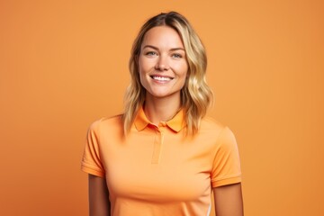 Portrait of a satisfied woman in her 30s wearing a sporty polo shirt against a pastel orange background. AI Generation