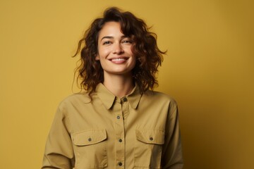 Portrait of a glad woman in her 30s sporting a vented fishing shirt against a soft yellow background. AI Generation