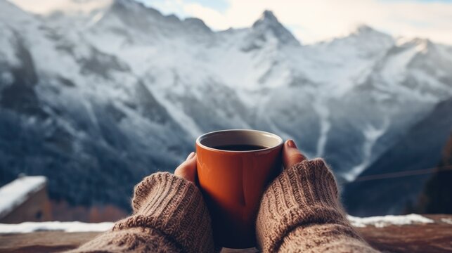 Hands woman holding hot drink cup relaxes in winter season with mountain view background.