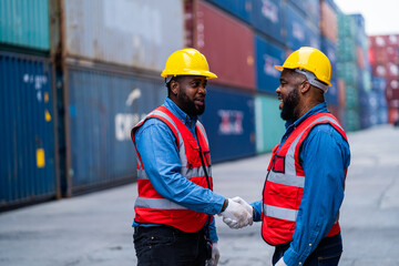 African engineers Supervising loading containers from cargo ships. logistics yard business Import and Export Freight Forwarding Industry