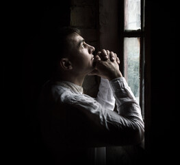 Praying man at the window