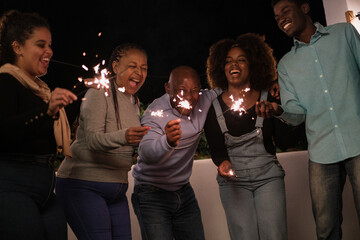 Family celebrating special days together with sparklers. Concepts: lifestyle, fun, party