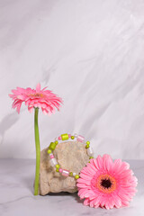 Colorful gem jewelry bracelet, accessories jade gift on stone and pink flower
