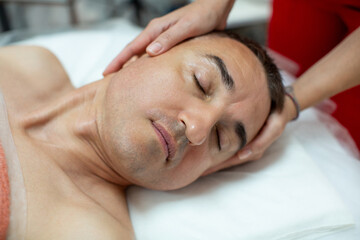 Fototapeta na wymiar Non-surgical facelift for man - Italian modeling massage Gym