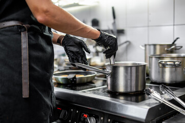 Chef hands cooking food in the restaurant kitchen