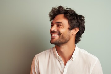 Fototapeta premium Portrait of a smiling man in his 30s donning a trendy cropped top against a pastel or soft colors background. AI Generation