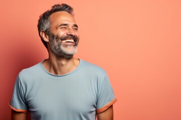 Portrait of a happy man in his 40s sporting a vintage band t-shirt against a pastel or soft colors background. AI Generation