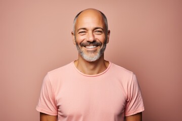 Portrait of a happy man in his 40s sporting a vintage band t-shirt against a pastel or soft colors...