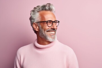 Portrait of a jovial man in his 50s wearing a cozy sweater against a pastel or soft colors...