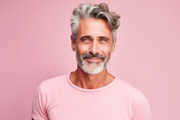 Obraz premium Portrait of a blissful man in his 50s donning a trendy cropped top against a pastel or soft colors background. AI Generation
