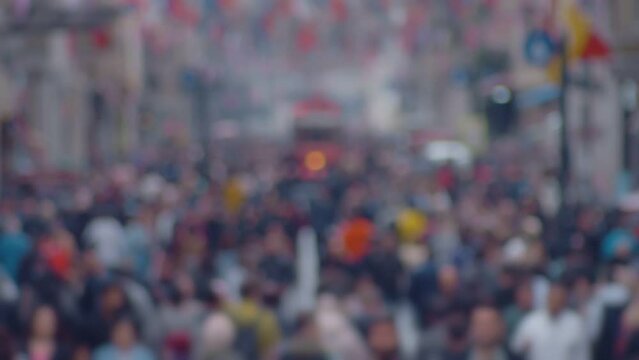 View of a crowd of people and a red tram on Istiklal Street in Istanbul in October 2023. Super blur slow motion