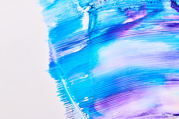 Acrylic multicolor paint blot, chaotic brushstroke, spot flowing on white paper background. Creative blue color backdrop, fluid art.