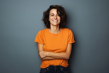 Portrait of a grinning woman in her 40s sporting a vintage band t-shirt against a solid color backdrop. AI Generation