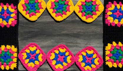 Colorful cotton granny square. Crochet texture close up photo.