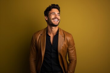 Fototapeta premium Portrait of a smiling man in his 20s sporting a stylish leather blazer against a solid color backdrop. AI Generation