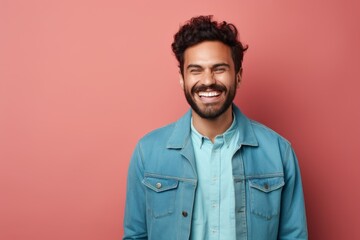 Obraz premium Portrait of a glad man in his 30s sporting a rugged denim jacket against a solid pastel color wall. AI Generation