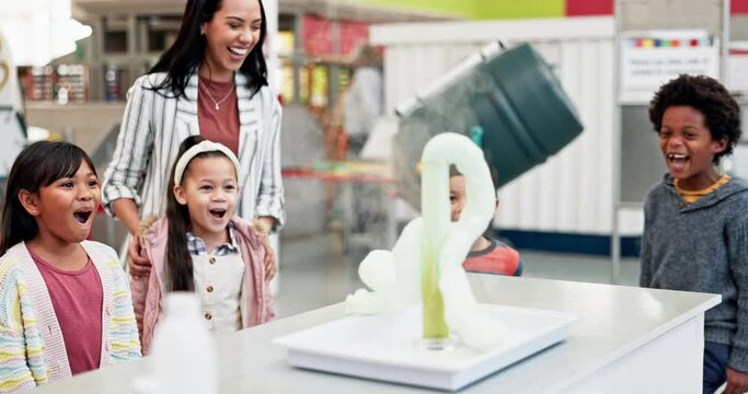 Science, teacher and chemistry experiment in classroom with excited children learning about chemical, explosion or reaction. Kids, applause and foam surprise from beaker in school, class or education