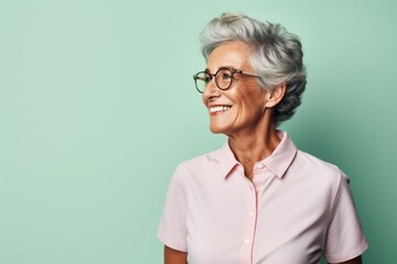 Portrait of a joyful man in his 80s donning a classy polo shirt against a solid pastel color wall. AI Generation