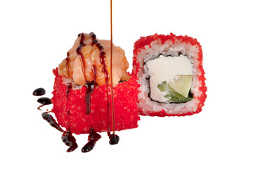 Sushi is rolled in red artificial caviar with rice, Philadelphia cheese and poured with soy sauce....