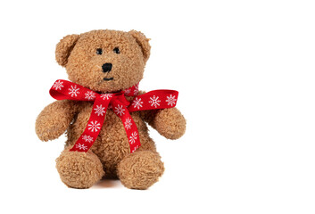 Vintage toy bear with Christmas bow on a white background.