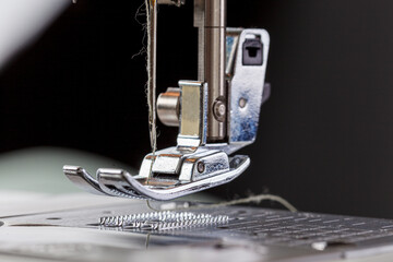 Sewing machine, stitching fabrics, needle in a round plan