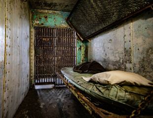 Interior of a prison cell. - obrazy, fototapety, plakaty