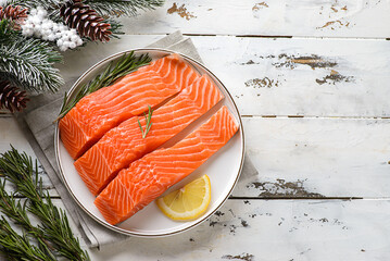 raw salmon fillet in a Christmas composition - obrazy, fototapety, plakaty