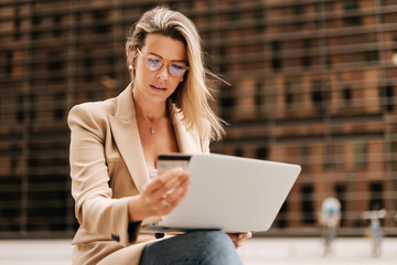 Woman buying online with a credit card and laptop..