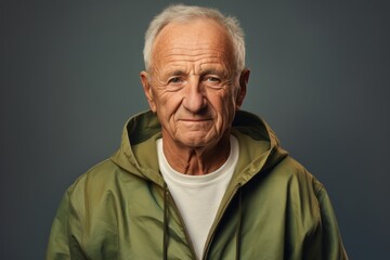 Portrait of a glad man in his 80s wearing a zip-up fleece hoodie against a plain white digital canvas. AI Generation
