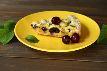 Delicious Quiche pie with cherry filling on yellow plate