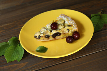 Delicious Quiche pie with cherry filling on yellow plate
