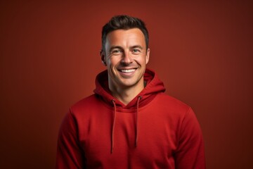 Fototapeta premium Portrait of a smiling man in his 30s wearing a thermal fleece pullover against a plain cyclorama studio wall. AI Generation