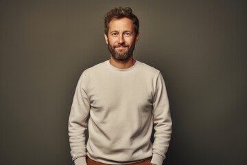 Portrait of a smiling man in his 30s wearing a thermal fleece pullover against a plain cyclorama studio wall. AI Generation - obrazy, fototapety, plakaty