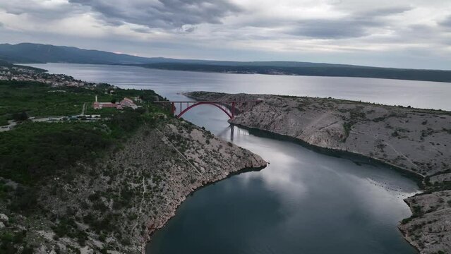 Aerial panoramic video with Maslenica bridge - a deck arch bridge near town of Zadar in Croatia with beautiful clouds over Adriatic sea