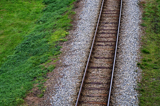 Railway bed. Fragment of railway tracks, top view, rails and sleepers.