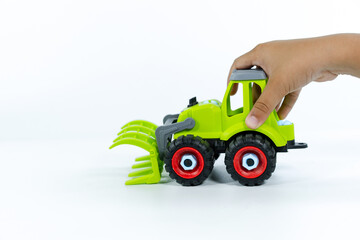 Close-up of a kid hand playing with the car close on a white background. Plastic child toy on white...