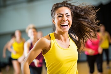 energetic girl in her 20s dancing in a zumba class