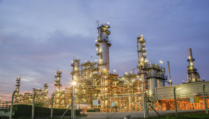 Oil refinery plant from industry zone, Aerial view oil and gas petrochemical industrial, Refinery factory oil storage tank and pipeline steel at night, Ecosystem and healthy environment concepts.