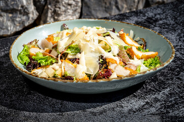 Sensational Salad Composition: A close-up view of a vibrant salad featuring crisp salad leaves, succulent breaded chicken, and cheese peels. Perfect for health-conscious individuals.