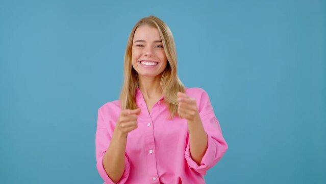 Emotional woman points at person and gives thumbs up sign