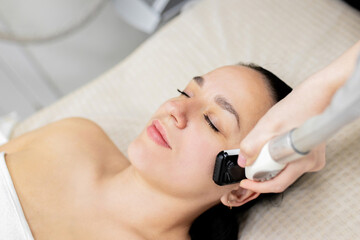 Microneedle RF lifting procedure. Hardware cosmetology. Beautician conducts a facial rejuvenation...