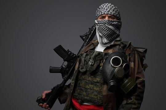 Militant from the Middle East, dressed in a white keffiyeh and camouflaged field attire, wielding an automatic rifle, set against a neutral gray backdrop