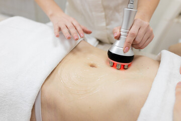RF body cavitation lifting procedure in a beauty salon. Ultrasound therapy to reduce fat and...