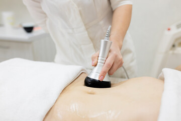RF body cavitation lifting procedure in a beauty salon. Ultrasound therapy to reduce fat and...