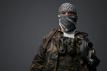 Middle Eastern radical fanatic soldier donning a white keffiyeh and camouflaged field uniform,...