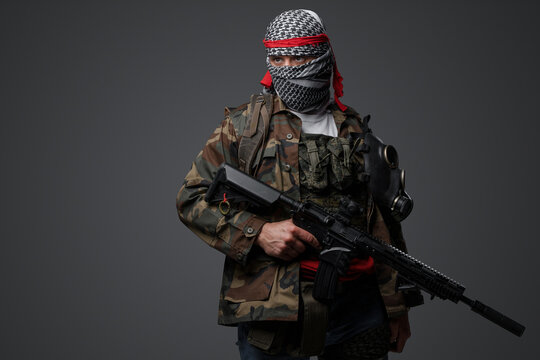 Militant from the Middle East, dressed in a white keffiyeh and camouflaged field attire, wielding an automatic rifle, set against a neutral gray backdrop